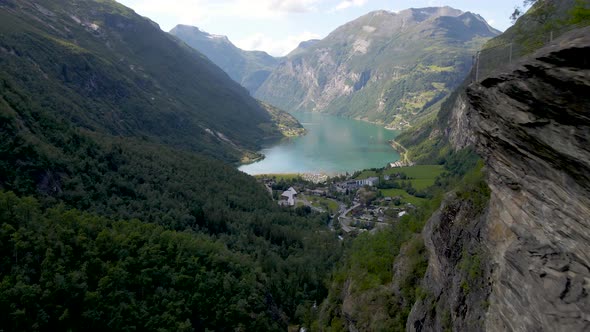 Serene Scenery From Geirangerfjord Norway Mountains and Emerald Sea Water - aerial shot alt