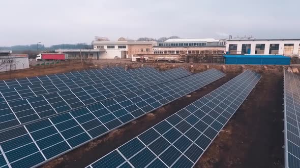 Solar panels farm on industrial factory background.  alt