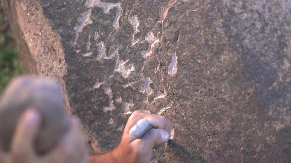 Ancient Man Cave Painting and Writing Historic Inscription Graffiti on Rock Surface With Iron Chisel