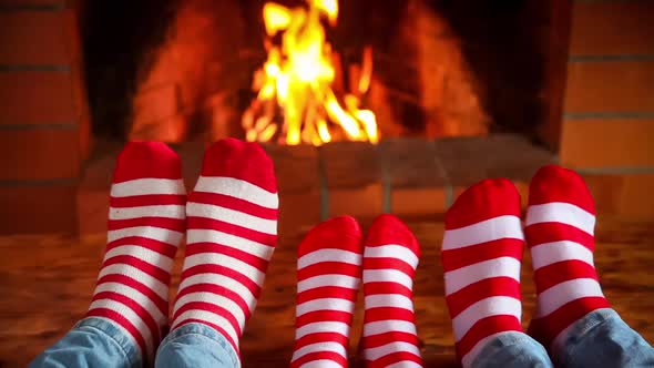 Family in Christmas Socks Near Fireplace