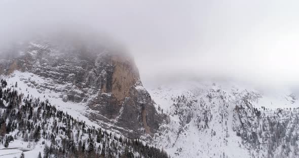 Backward Aerial with Snowy Mountain and Woods Forest at Sella Pass alt