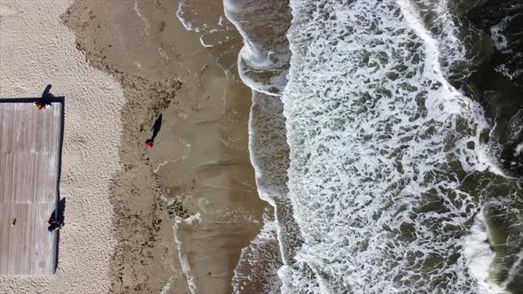 People Walking and Relaxing on Beach on Sunny Day alt
