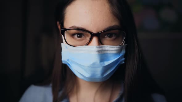 Young Brunette Woman Taking Off Black Face Mask After Being Vaccinated alt