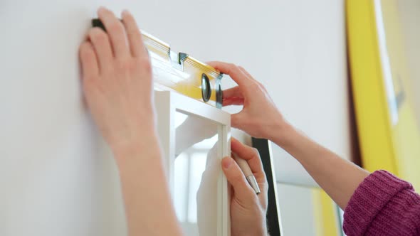 Creative Couple Hangs Painting in Modern Apartment