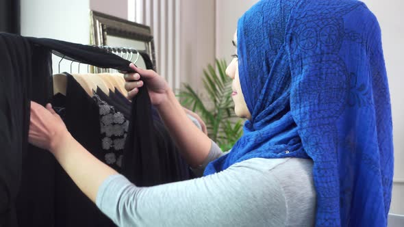 Asian muslim woman designer as a startup business owner working in her tailor shop