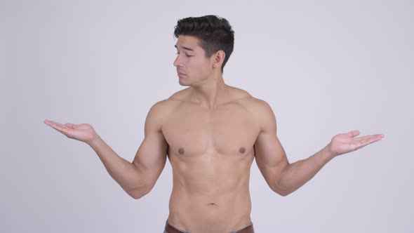Happy Young Handsome Muscular Shirtless Man Comparing Something alt