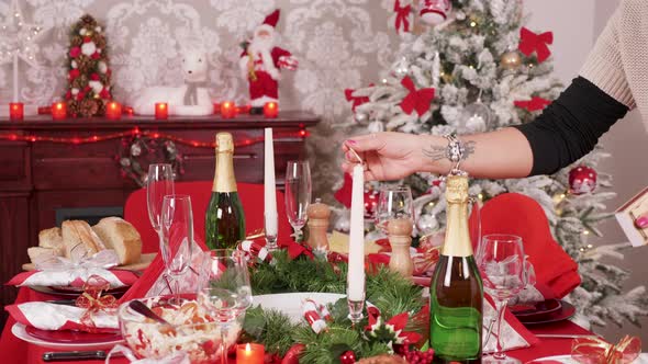 Woman Lighting Candles for Christmas Celebration with Her Big Family alt