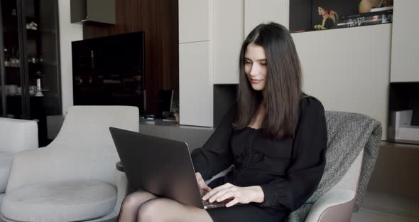 Young Adult Business Woman Typing on Laptop Computer Working in Internet alt