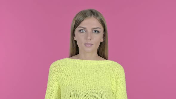 Beautiful Young Girl Finger on Lips Pink Background alt