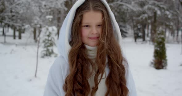 A Girl In The Form Of An Angel Rides Through A Snowy Forest And Carries A Gift.