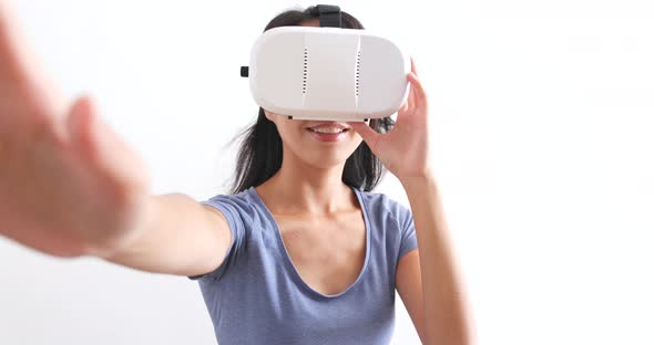 Woman looking though VR device  alt