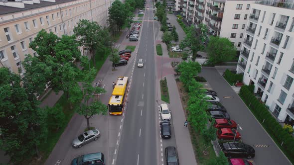 Aerial Drone Footage City Bus Drives Down the Street