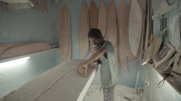 Artisan Making New Surfboard in Workshop alt