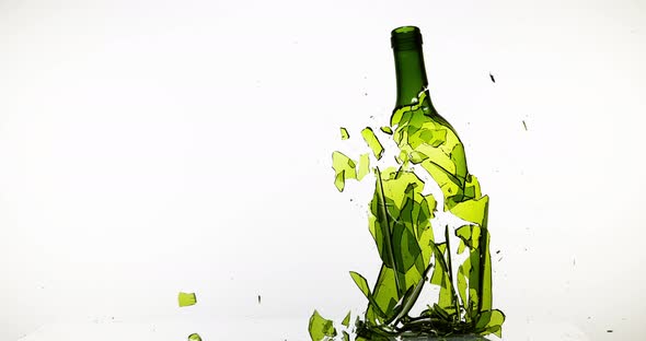 Bottle of White Wine Breaking against White Background, Slow motion 4K