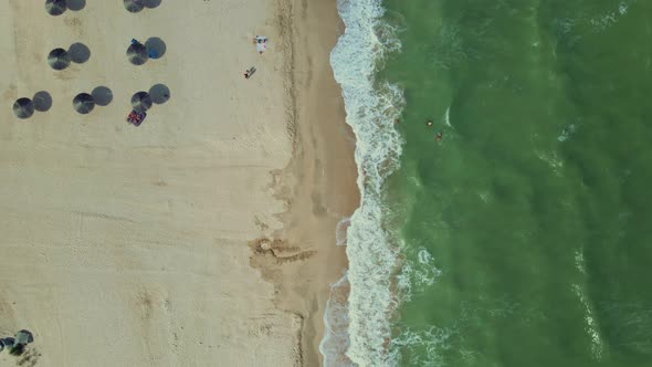 Aerial Top Down View To Sandy Seaside with Straw Sun Umbrellas alt