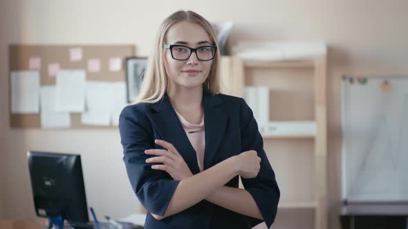 Portrait of a beautiful women entrepreneur standing in the office and smiling at the camera. alt