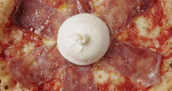 Rotating Prosciutto Pizza with Cheese on White Background alt