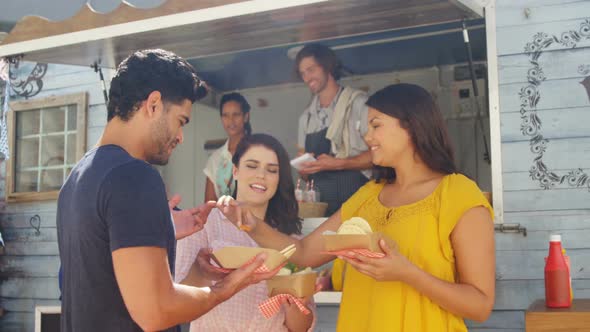 Smiling friends eating snacks alt