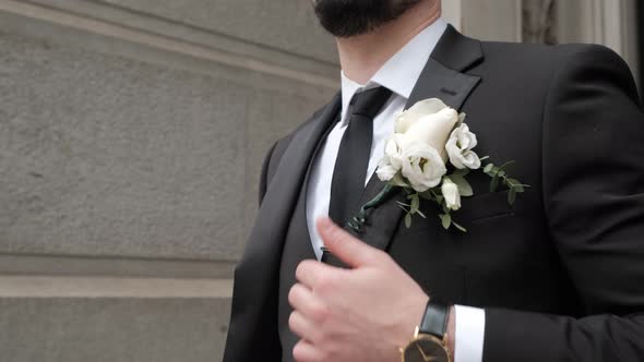 Close Up View of a Stylish Guy's Jacket and Wedding Boutonniere alt
