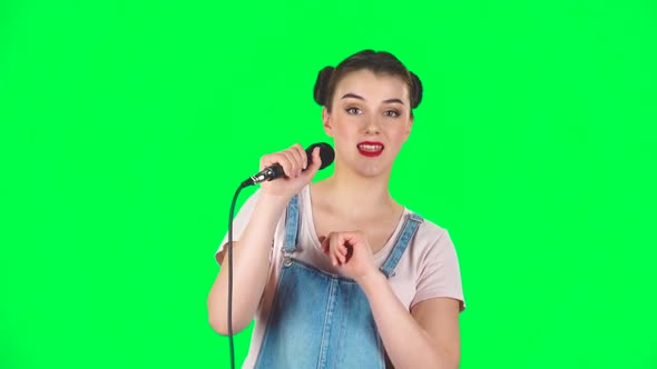 Attractive Girl Sings Into a Microphone and Moves To the Beat of Music, Slow Motion alt