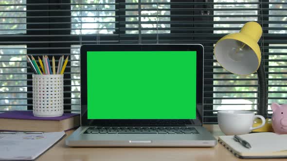 Chroma key green screen laptop computer set up for work on home office