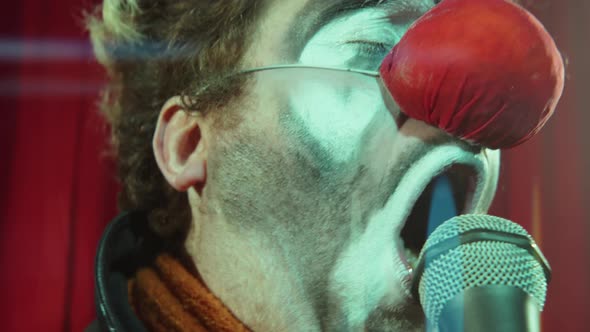 Clown Singing in Mic on Stage alt