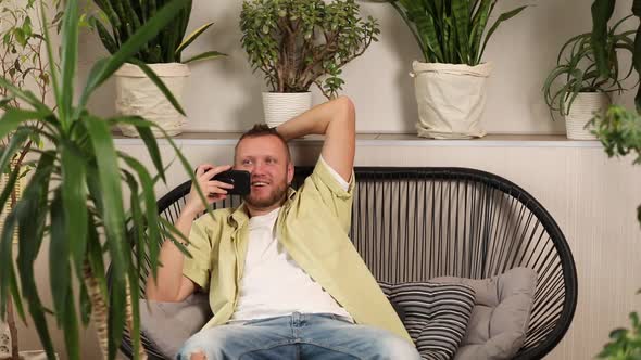 Smiling Man Record Audio Message on Phone Male User Talk Speak on Loudspeaker