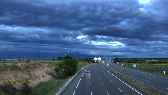 Nice timelapse with the traffic of a highway, with the sunset and dark clouds that announce the stor alt