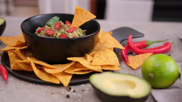 Nachos Chips and Freshly Made Guacamole Dip Sauce in Marble Bowl Mortar alt