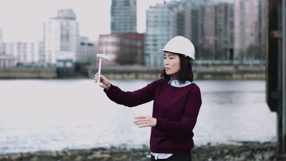 Engineer working on a Wind Turbine project at river bank