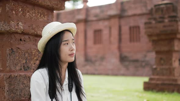 Woman sitting and resting ancient temple alt