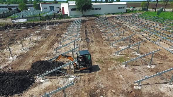 Industry machinery for construction. Aerial view of arm excavator working on field alt