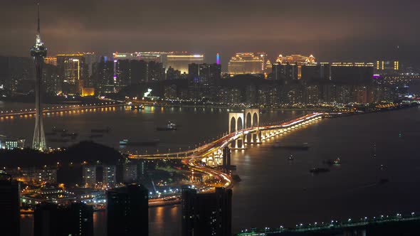 Macau Tower and Bridge Traffic Cityscape Night Timelapse Pan Up alt