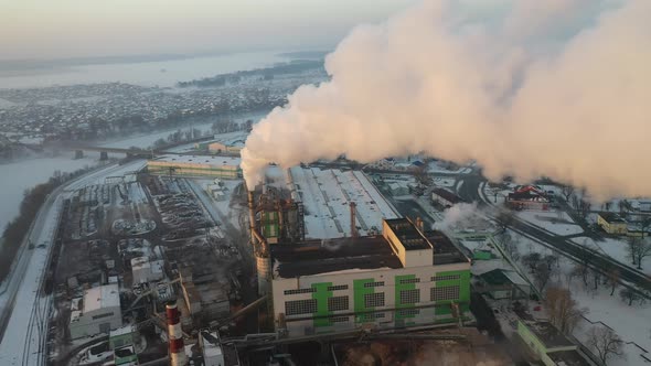 smoke from factory chimneys on the background of sunrise