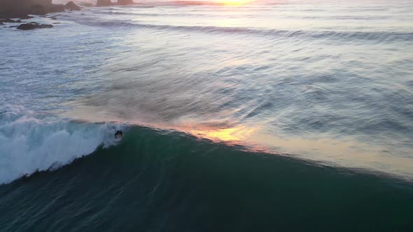 Surf, Epic Sunset, Punta de Lobos, pichilemu, chile. man Surfing sport,aerial shot with drone alt