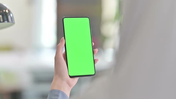Rear View of Arab Woman Using Smartphone with Chroma Key Screen alt