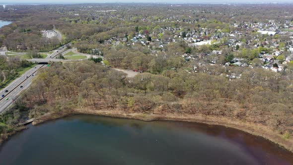 An aerial view of reflective lakes during the day. The drone camera dolly in and pan left over the l alt
