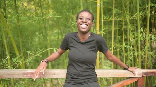 Attractive Happy Smiling Young Natural Beauty Short Haired African Black Woman Laughing Leans on a