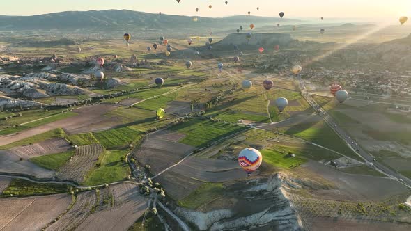 4K Aerial view of Goreme. Colorful hot air balloons fly over the valleys. alt
