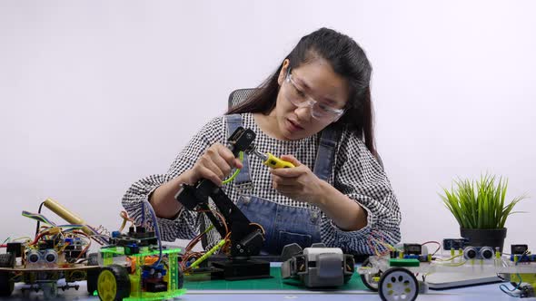 Robotics Engineers or student testing a robot. Innovative technology mechanical alt
