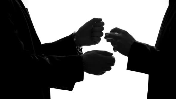 Criminal Businessman Giving Bribe and Releasing Prison, Taking Handcuffs Off alt