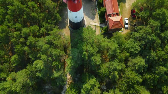 Aerial close-up view of Stilo Lighthouse and green forest around it - lighthouse located in Osetnik alt