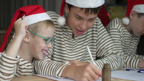 cheerful child brothers write a letter to santa claus