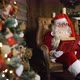 Santa Claus Pulls Out Old Red Silk Album Near Christmas Tree with Toys and Lights - VideoHive Item for Sale