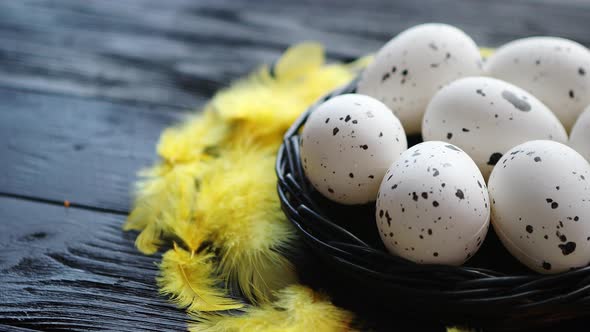 Whole Chicken Eggs in a Nest on a Black Rustic Wooden Background. Easter Symbols alt