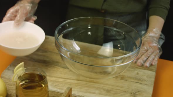 Pour the Water with Yeast Into the Transparent Bowl alt