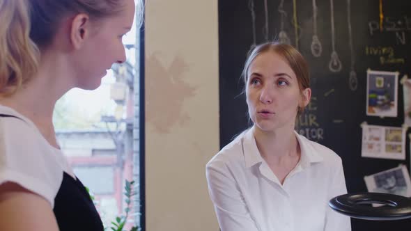 Female Designers Discussing Sketch on Interior 