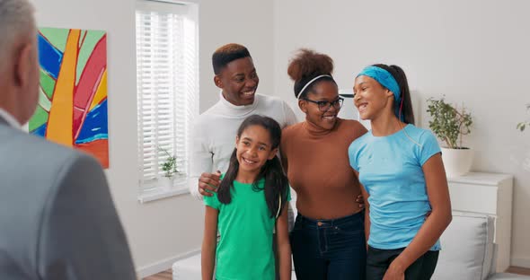 Smiling Family is Viewing Apartment for Rent Sale Parents are Embracing Their Children They are alt