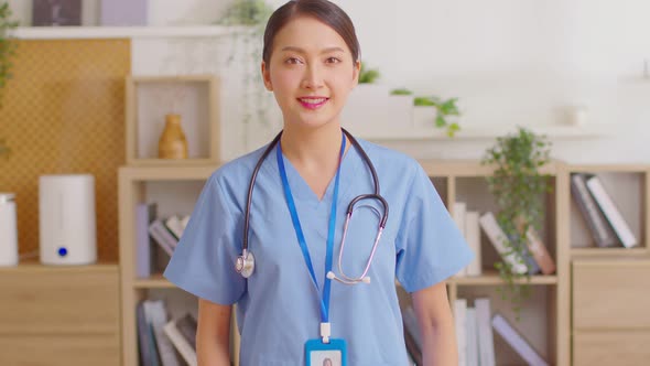 Asian female doctor with a stethoscope smile looking at camera.Nurses wear scrub smile with heartwar alt