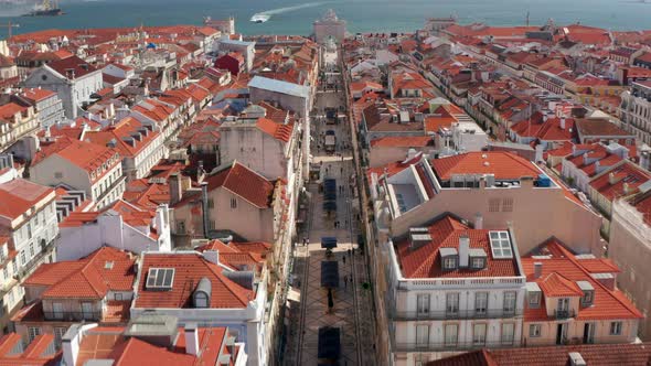 Drone Camera Flying Forward and Following Rua Augusta Promenade Towards Stone Triumphal Arch Rua alt